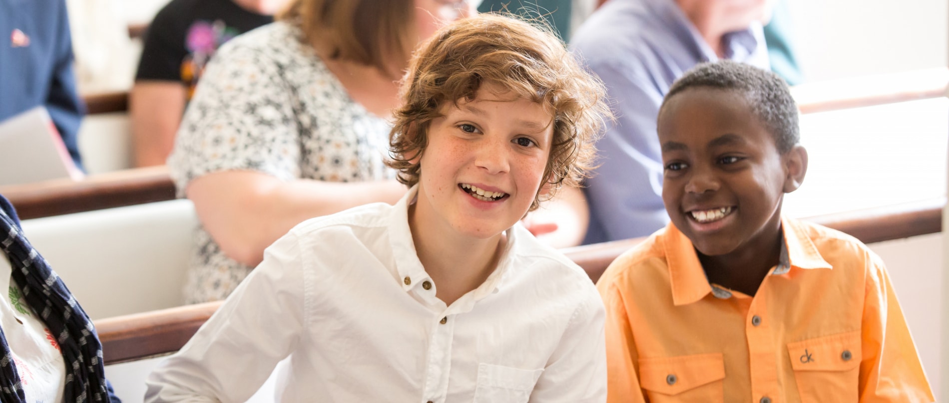 Two teenage boys smile during worship