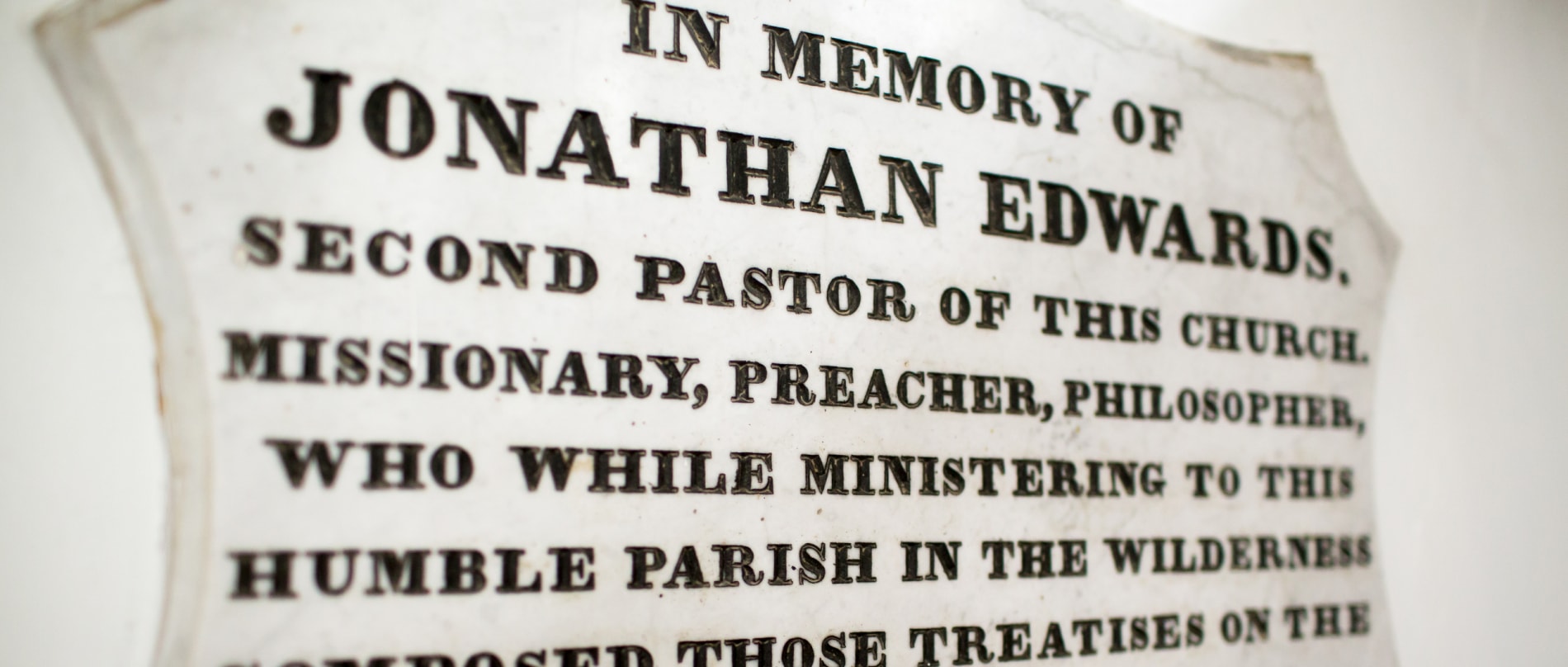 Memorial plaque in the church sanctuary, with the following text: In memory of Jonathan Edwards, second pastor of this church, missionary, preacher, philosopher, who while ministering to this humble parish in the wilderness composed those treatises on the freedom of the will and on original sin which have given him universal fame.