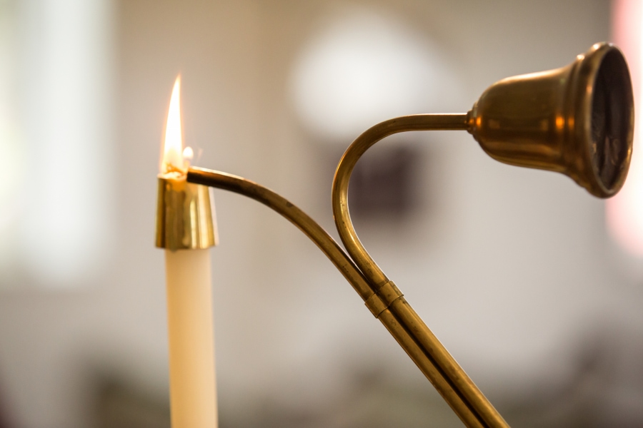 A candle is lit in a church