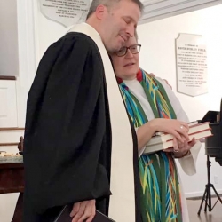 Rev. Brent Damrow hugs Rev. Patty Fox