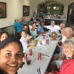 Volunteers pose at a meal table for a selfie