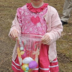 A tottler shows off the Easter eggs she has found