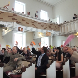 The congregation waves decorative ribbons while singing Alleluia