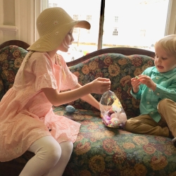 A brother and sister compare their Easter egg hunt treasures