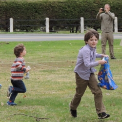 Boys run on the lawn in search of Easter eggs.