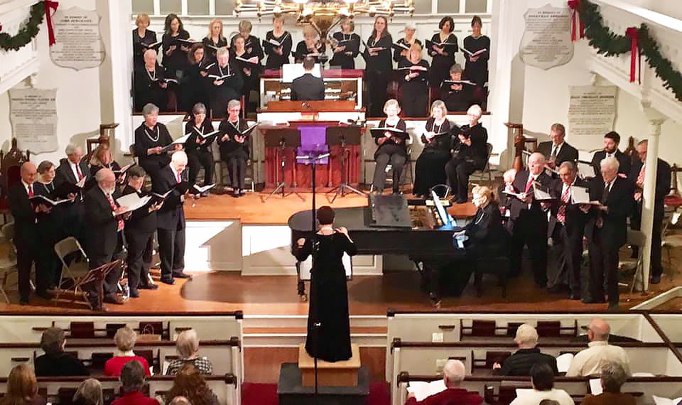 A choral group sings in a church sanctuary