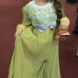 A girl dressed as a princess curtsies