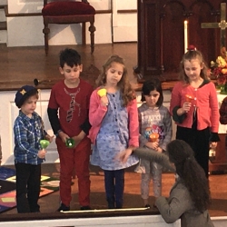 A woman conducts the children's choir