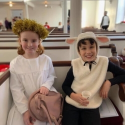 A girl dressed as an angel and a boy dressed as a sheep.