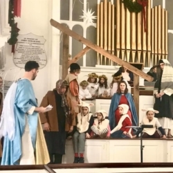 Angels, shepherds and sheep adore the baby Jesus