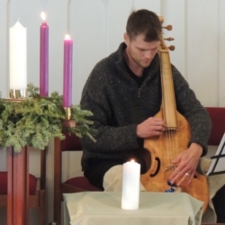 A man plays the viola da gamba