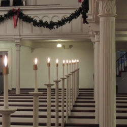 Candles illuminate the pews of the church