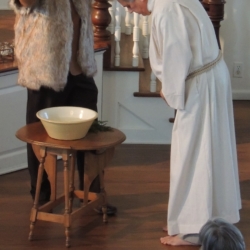 Two men dramatize the story of Jesus' baptism by John.