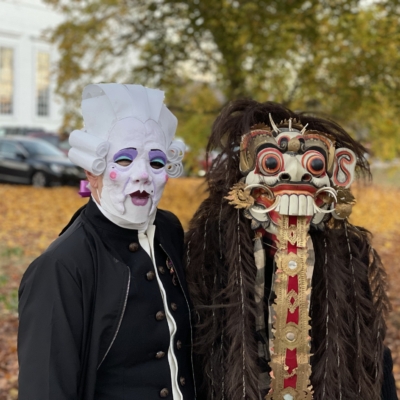 Two people dressed in creative masks