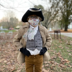 A boy dressed as a colonial soldier
